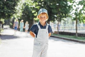 Cute boy posing for photo outdoors.