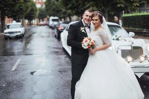 Happy young couple near the car on the road photo