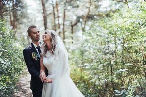 groom at a park on their wedding day photo