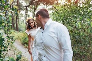 Beautiful happy couple on a walk in the woods photo