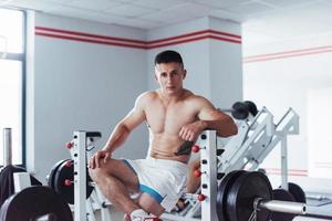 Portrait of a handsome man doing exercises in the gym photo
