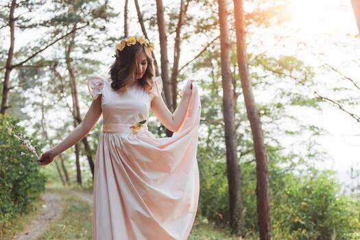 Happy young woman in long dress a beautiful pine forest photo