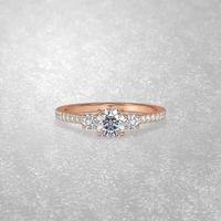 3 stone engagement ring laying down position in rose gold 3D render photo