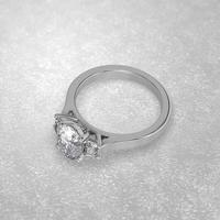 three stone engagement ring laying down position in metal gold 3D render photo