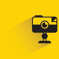 camera on stand yellow background vector