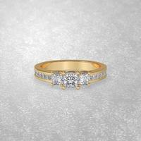 3 stone engagement ring laying down position in yellow gold 3D render photo