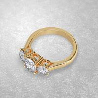 3 stone engagement ring laying down position in yellow gold 3D render photo