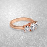 3 stone engagement ring laying down position in rose gold 3D render photo