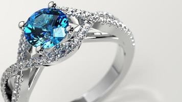 closeup shot with aquamarine solitaire criss cross engagement ring photo