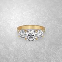 3 stone engagement ring laying down position in yellow gold 3D render photo