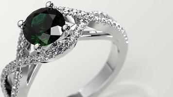 closeup shot with emerald solitaire criss cross engagement ring photo