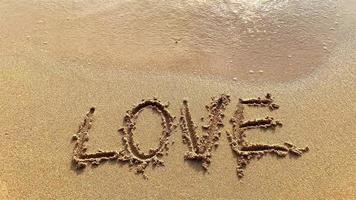 Soft waves on the beach with love text