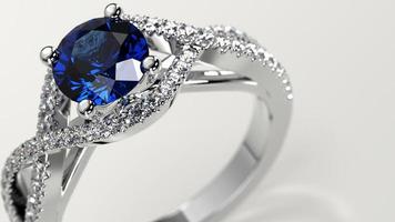 closeup shot with sapphire solitaire criss cross engagement ring photo