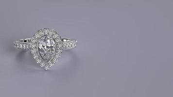 isolated white gold engagement ring with pear shape diamond stone photo