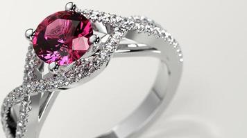 closeup shot with pink tourmaline solitaire criss cross engagement ring photo