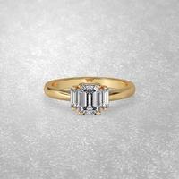 3 stone engagement ring laying down position in yellow gold 3D render photo
