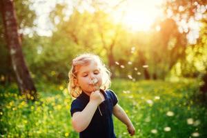 child with dandelion photo