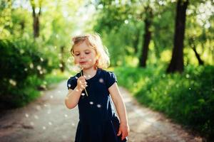 child with dandelion photo