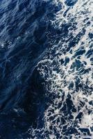 Textural background. Blue waves of the sea photo