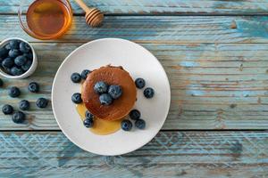 chocolate pancake stack with blueberry and honey photo