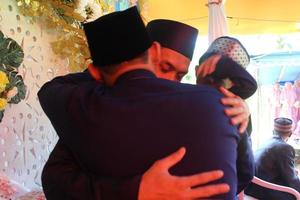 June 2, 2021 in Cianjur Regency, West Java, Indonesia, a groom hugs his brother.  A photo that fits the theme of a touching meeting.
