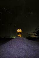 A toy with stars in the background at night photo