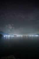 Stunning stars rises above the dam at night photo