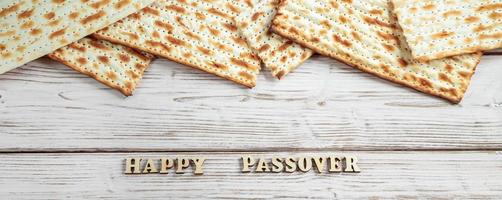 Concept of Jewish holiday Pesach. Passover. Traditional matzah on a white wooden background.
