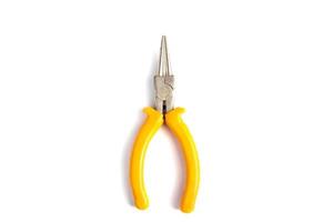 Pliers with yellow insulating handles on white background. photo