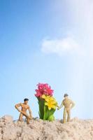 Miniature people gardener working on cactus plants photo