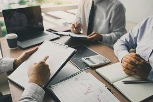 Businessmen explain about quarterly results with colleagues and entrepreneurs and are discussing future financial planning at the office. photo