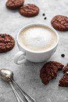 Coffee and cookies. Oat, healthy cookies and coffee cup with milk foam, breakfast concept.