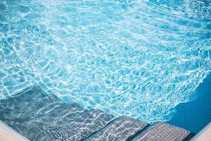 Wavy water surface of swimming pool. Blue ripped water in swimming pool summer vacation banner, outdoor relax recreational fun activity photo