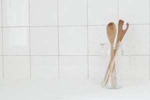 Glass Jug with Wooden Spoon and Chopsticks photo