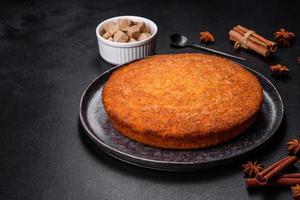 Pumpkin pie on marble cutting board. Dark background. Copy space photo