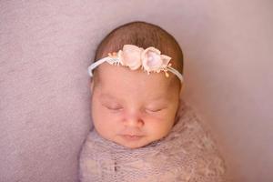Close-up beautiful sleeping baby girl. Newborn baby girl, asleep photo