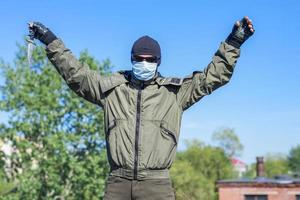 Criminal surrenders to law enforcement by raising his hands up and throwing a knife to the ground photo