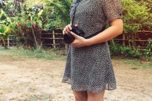 Vintage lifestyle young woman photographer young woman holding a camera lens. photo