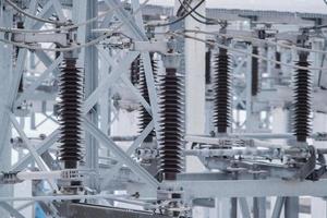 High-voltage oil circuit breakers at an electrical substation. Electric power elements of urban infrastructure. photo