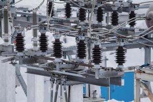 High-voltage oil circuit breakers at an electrical substation. Electric power elements of urban infrastructure. photo