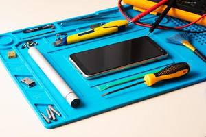 Flat lay image of dismantling the broken smart phone for preparing to repair or replace some components, Top view photo