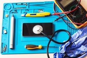 Flat lay image of dismantling the broken smart phone for preparing to repair or replace some components, Top view photo