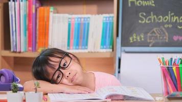 estudante asiática que está chateada enquanto estuda em casa durante a quarentena. novo normal. Educação escolar em casa.