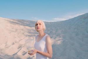 blonde woman in the desert with goldfish in her hands photo