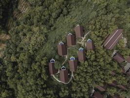 Aerial view of beautiful isolated villa with small swimming pool in the middle of a forest photo