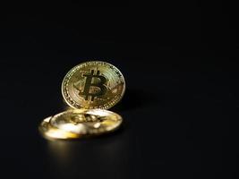 Bitcoin Coins as Cryptocurrency placed on a black background photo