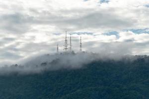 Telecommunication tower at top of hill photo