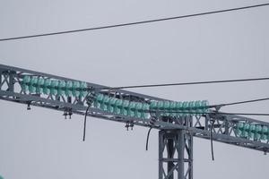 High-voltage line insulators at an electrical substation. Electric power elements of urban infrastructure. photo