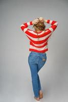 young beautiful woman posing in Studio on a background of the view from the back photo