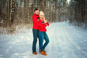 beautiful young couple in winter in the woods, hug, happy romance photo